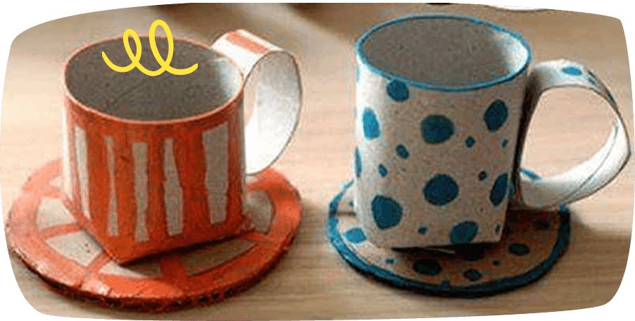 Two handmade ceramic mugs with saucers, one orange with white stripes and one white with blue polka dots, placed on a wooden surface.