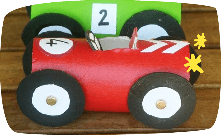 Two handmade toy racing cars crafted from painted toilet paper rolls, with black cardboard wheels and number decorations.